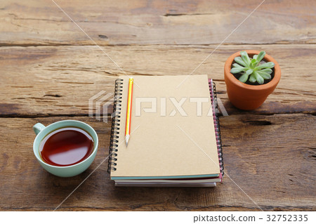Red tea and notebook with plant Red tea and notebook with plant 32752335