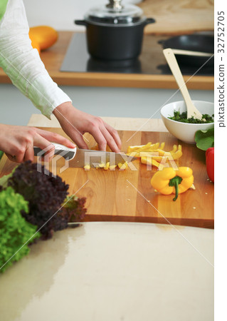 Closeup of human hands cooking vegetables salad in Closeup of human hands cooking vegetables salad in 32752705