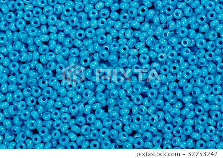 Multicolored blue glass seed beads background. Multicolored blue glass seed beads background. 32753242