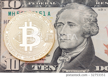 Golden Bit-coin on US dolllar close up. Golden Bit-coin on US dolllar close up. 32753351