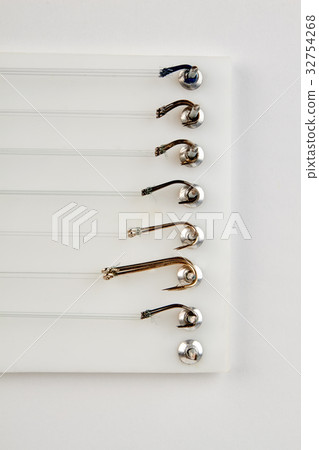 Vertical image of metallic hooks. 32754268