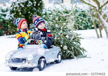 Two little kid boys driving toy car with Christmas Two little kid boys driving toy car with Christmas 32754632
