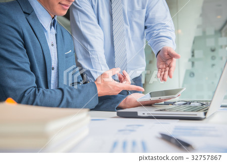 two businessmen discussing project with laptop two businessmen discussing project with laptop 32757867