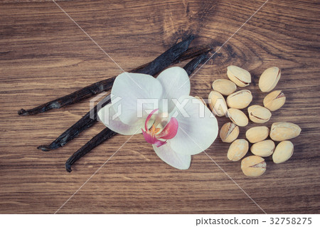 Pistachio nuts, blooming orchid and vanilla sticks Pistachio nuts, blooming orchid and vanilla sticks 32758275