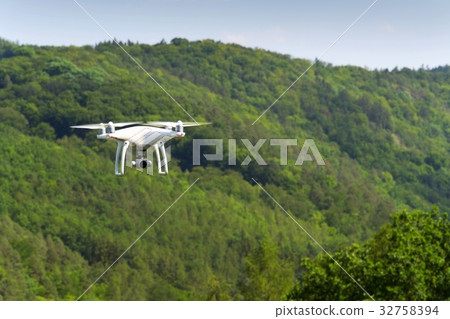 White drone quadrocopter with camera flying 32758394