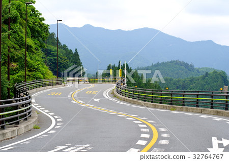 連綿不斷的曲線道路在鬱鬱蔥蔥的山脈中 連綿不斷的曲線道路在鬱鬱蔥蔥的山脈中 32764767