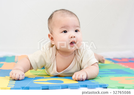 Portrait of adorable infant baby girl lying 32765086