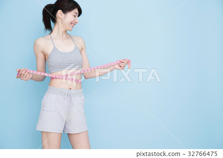 Woman diet young woman fitness blue back sport Woman diet young woman fitness blue back sport 32766475