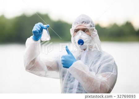 Chemist with test-tube , blurred background 32769893