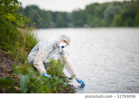 Environmentalist takes sample of water Environmentalist takes sample of water 32769896