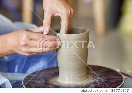 Creating jar or vase of clay. Woman hands Creating jar or vase of clay. Woman hands 32771597