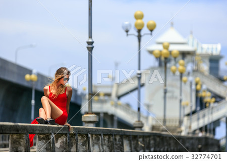 Young Woman Sitting on The Sarasin Bridge Young Woman Sitting on The Sarasin Bridge 32774701