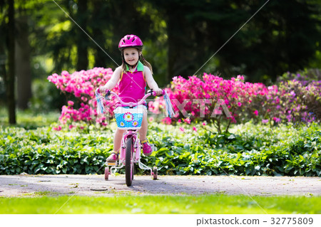Child riding bike. Kid on bicycle. 32775809