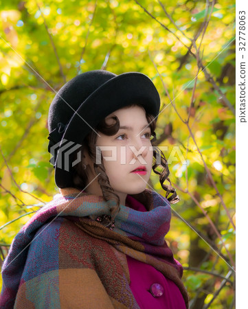 Portrait girl in bright crimson coat in autumn day 32778063