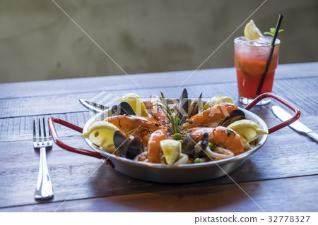 Paella with seafood vegetables and saffron Paella with seafood vegetables and saffron 32778327