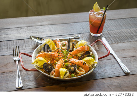 Paella with seafood vegetables and saffron Paella with seafood vegetables and saffron 32778328