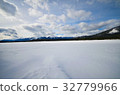 frozen lake and mountains covered with snow 32779966