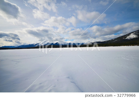 frozen lake and mountains covered with snow frozen lake and mountains covered with snow 32779966