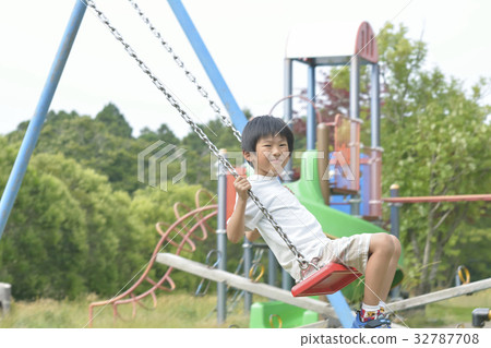 A boy playing with a swing A boy playing with a swing 32787708