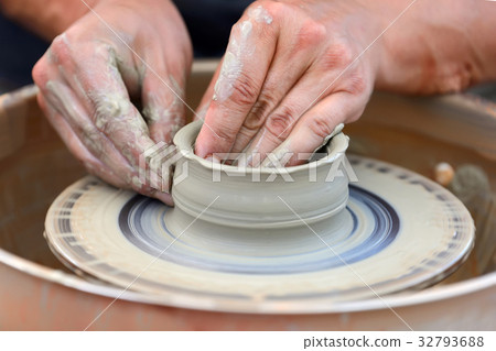 Potter making ceramic pot on the pottery wheel Potter making ceramic pot on the pottery wheel 32793688