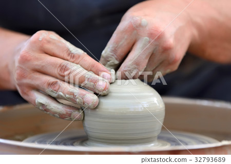 Potter making ceramic pot on the pottery wheel Potter making ceramic pot on the pottery wheel 32793689