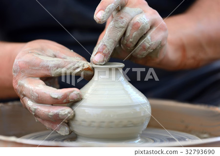 Potter making ceramic pot on the pottery wheel 32793690