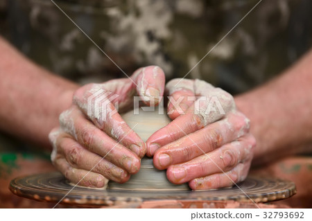 Potter making ceramic pot on the pottery wheel 32793692