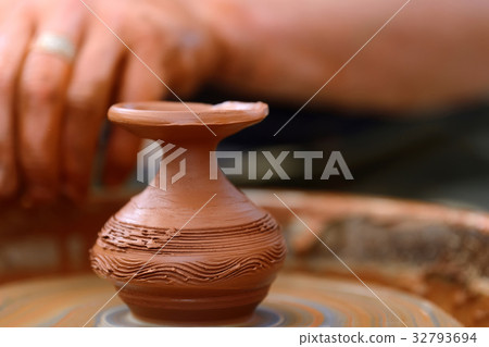 Potter making ceramic pot on the pottery wheel Potter making ceramic pot on the pottery wheel 32793694