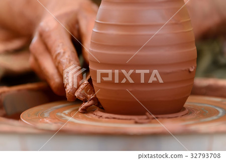 Potter making ceramic pot on the pottery wheel 32793708