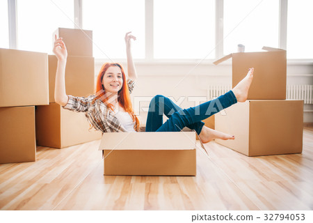 Woman sitting in carton box, housewarming 32794053