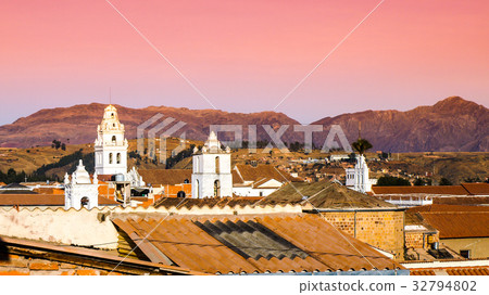 White colonial bell towers and orange rooftops in 32794802