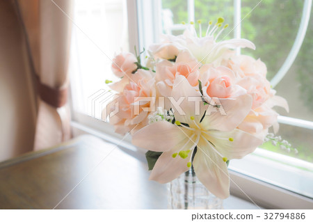Flowers in a Glass Vase on table near window. Flowers in a Glass Vase on table near window. 32794886
