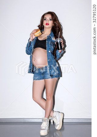 Pregnant woman eats fast food and soda Pregnant woman eats fast food and soda 32795120