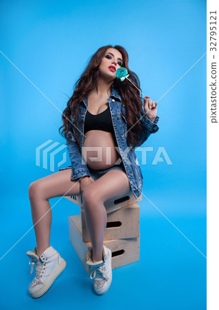 Pregnant woman delights her lollipop Pregnant woman delights her lollipop 32795121