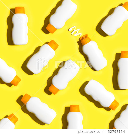 Sunblock bottles a yellow background 32797134
