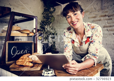 Adult Man Using Tablet in Bakery Shop Adult Man Using Tablet in Bakery Shop 32798923