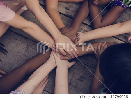 Diverse hands are join together on the wooden table Diverse hands are join together on the wooden table 32799008