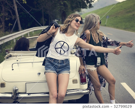Woman Hitch Hiking on The Street Side Near The Broke Down Car 32799029