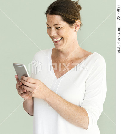 Caucasian Woman is Smiling with Smartphone Caucasian Woman is Smiling with Smartphone 32800955