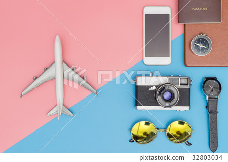 Toy plane with travel objects on blue and pink Toy plane with travel objects on blue and pink 32803034
