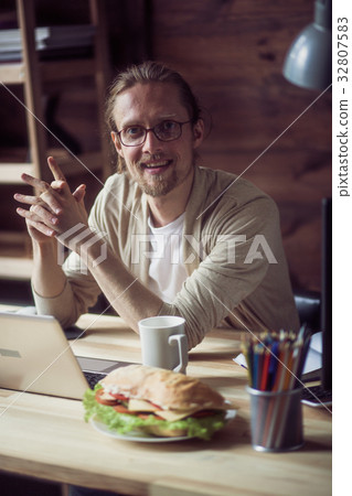 Young happy man working on freelance. 32807583