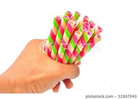 Hand grip colorful wafer roll isolated Hand grip colorful wafer roll isolated 32807840