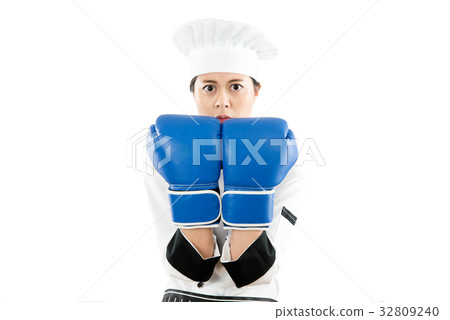 chef wearing boxing gloves ready to fight 32809240