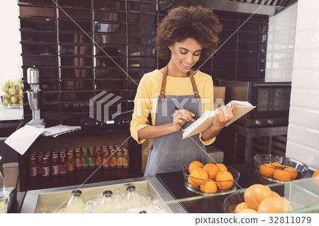 Cheerful mulatto woman is laboring in vegetarian Cheerful mulatto woman is laboring in vegetarian 32811079