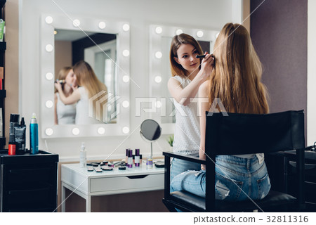 Professional makeup artist working on young girl Professional makeup artist working on young girl 32811316