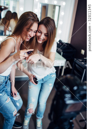 Two sisters testing foundation product cream Two sisters testing foundation product cream 32811345