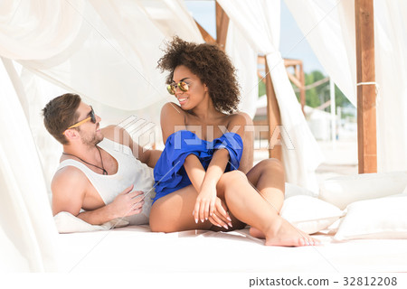 Happy youthful couple resting on summer resort Happy youthful couple resting on summer resort 32812208