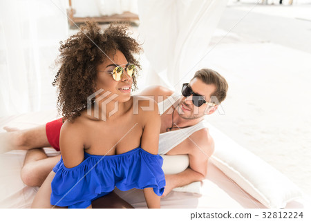 Jolly youthful couple resting together on summer 32812224