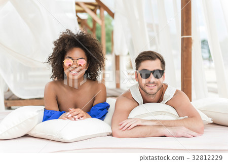 Cheerful young couple feeling pleasure resting on 32812229