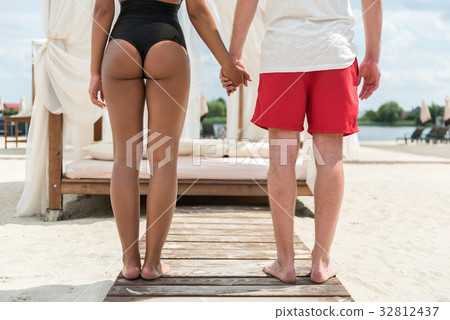 Youthful couple in love relaxing on river shore 32812437